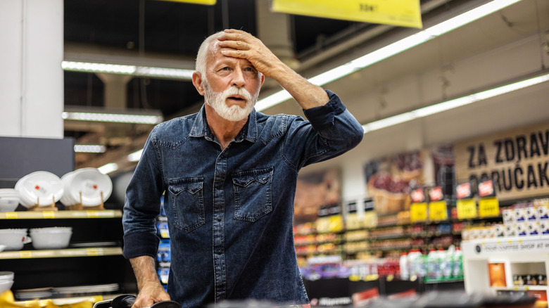 A man looking shocked in a grocery store