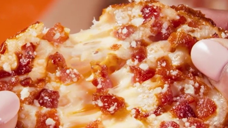 hand holding Bacon Cheese Crazy Puff
