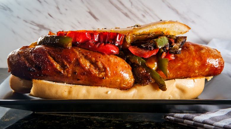 Grilled sausage, peppers, and onion on roll