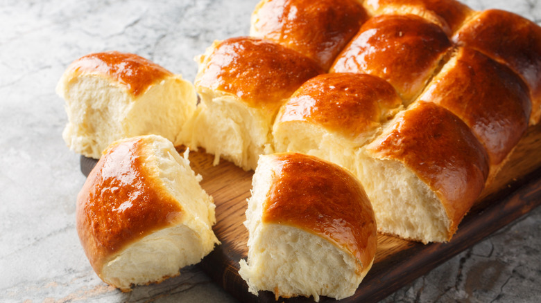 Dinner rolls on a wooden board