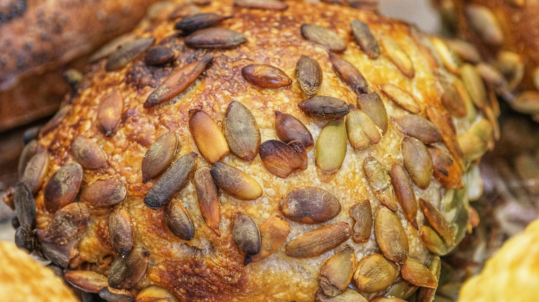 A close-up of freshly baked, seed-topped rolls