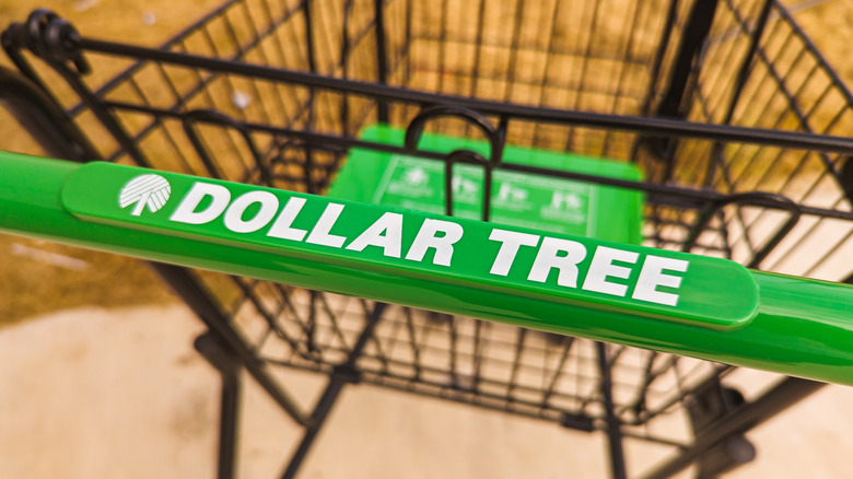 A shopping cart with a green handle labeled with "DOLLAR TREE"