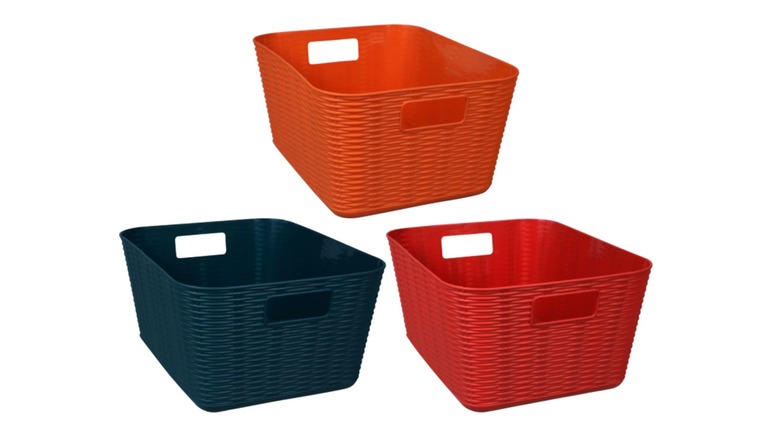 Blue, orange, and red plastic woven baskets on a white background