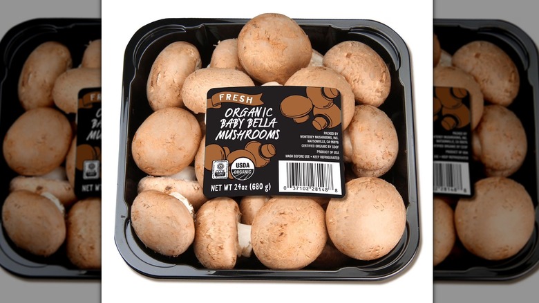 Container of organic baby bella mushrooms.