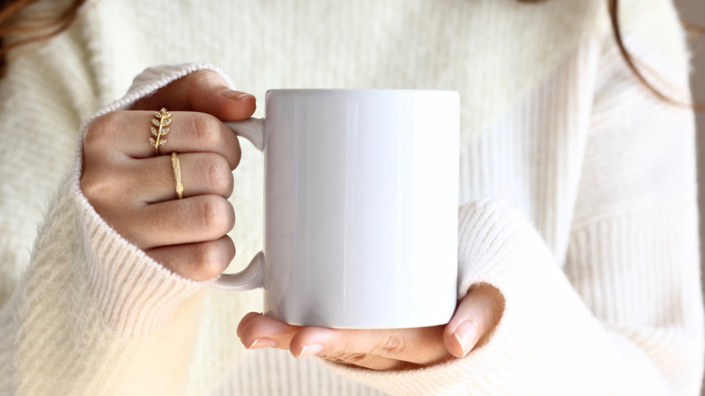 Woman's hands holding mug
