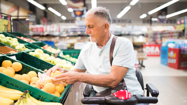 an older gentleman with gray hair is bagging grapefruits