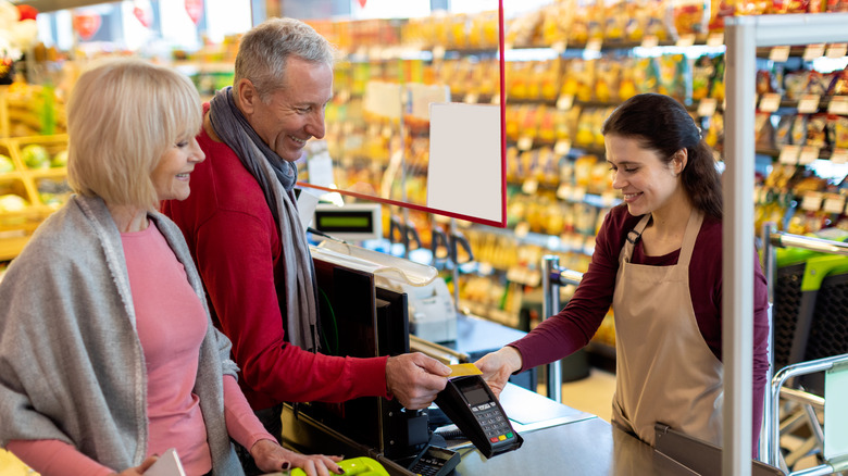 older couple ringing up at checkstand