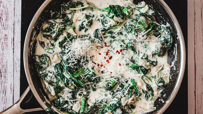 Parmesan cheese on creamed spinach pan