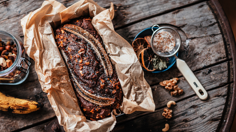 banana bread in tin on rustic table