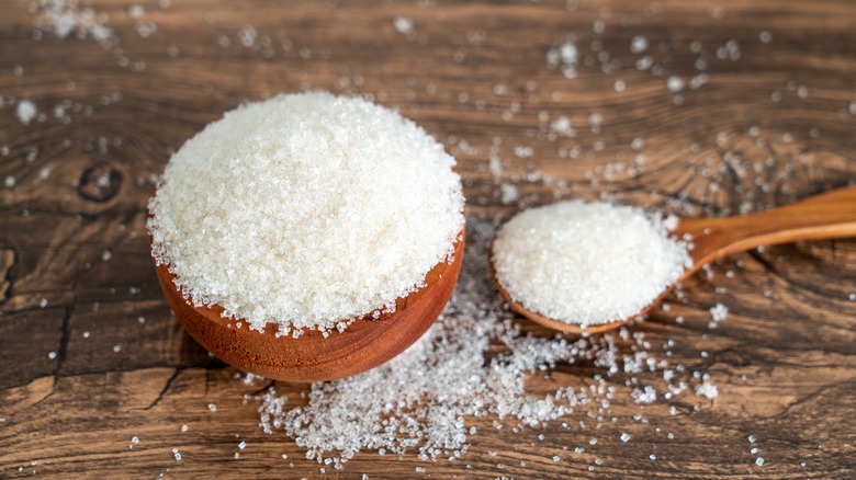 sugar in wooden bowl and a wooden spoon