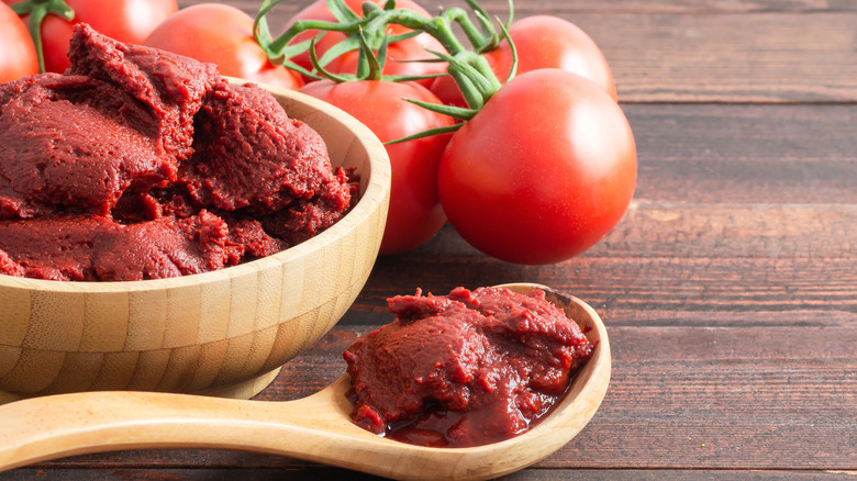 tomato paste alongside fresh tomatoes