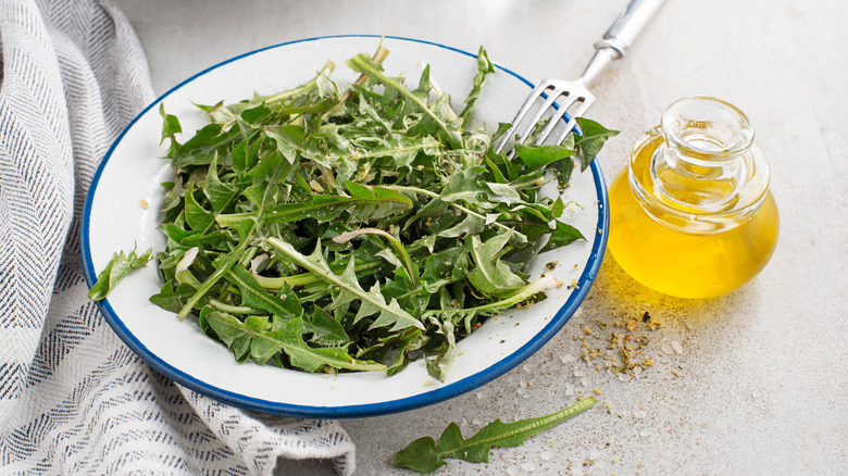 Two woman preparing dandelions for a salad