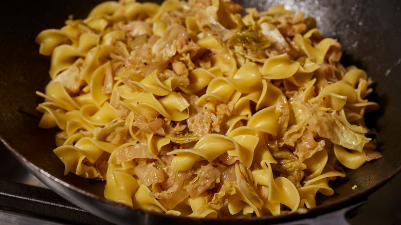 Cooked egg noodles and onions