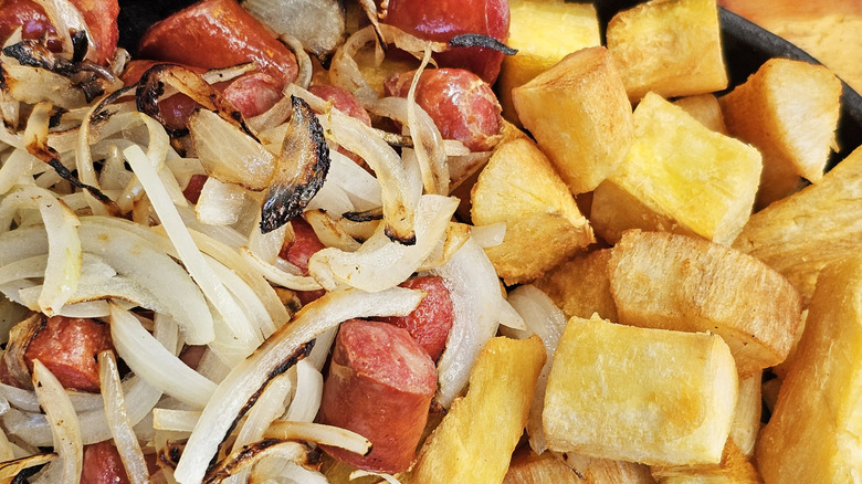 Sliced onions, sliced meat, and diced potatoes