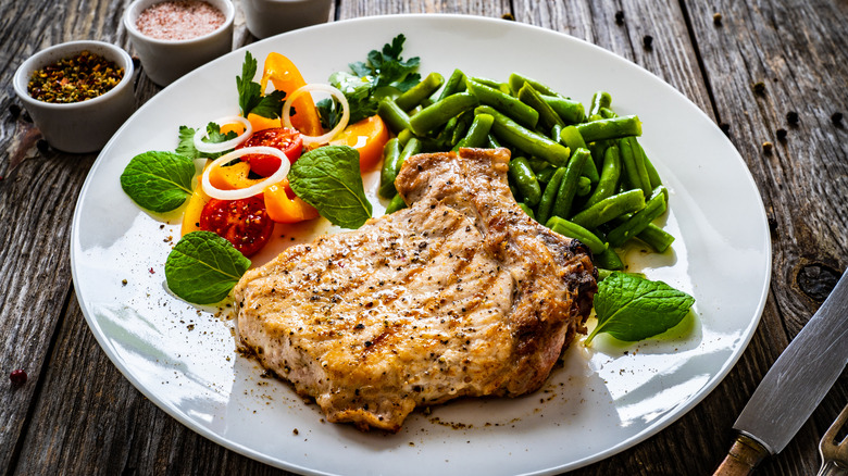 Pork chops with green beans and salad