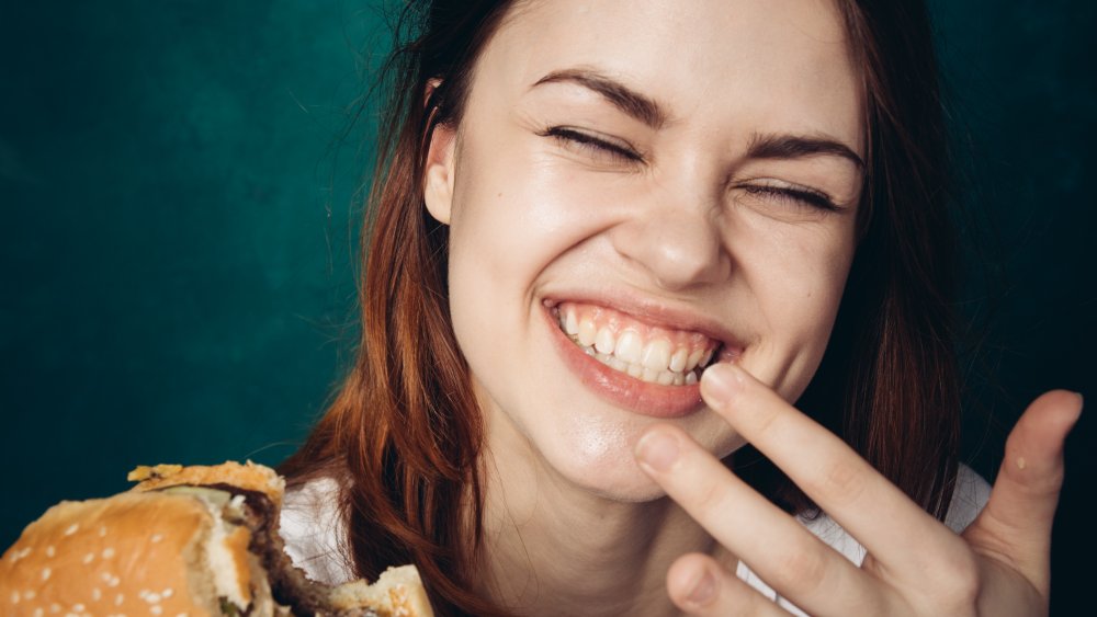 Woman eating hamburger