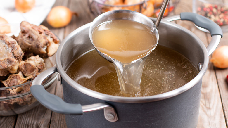 saucepan with ladle and broth