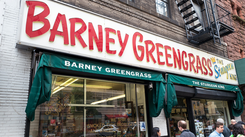 Exterior of Barney Greengrass deli during day with group of people outside