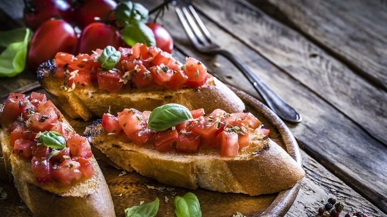 bruschetta with diced tomatoes and basil on plate