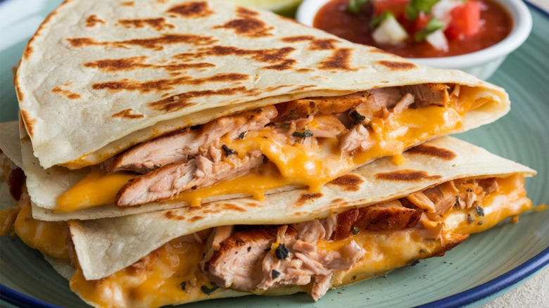 close up of chicken and cheese quesadillas with side of salsa