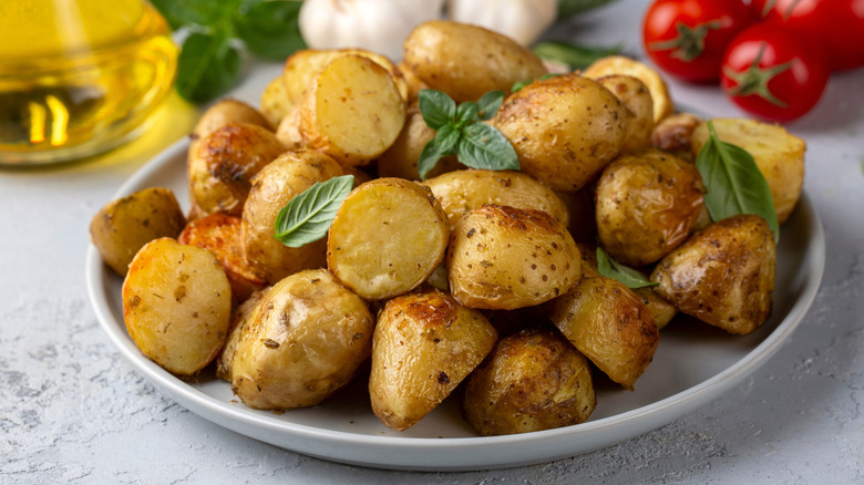 A plate of roasted baby potatoes with fresh herbs