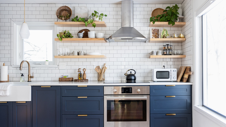 A tidy, minimalistic kitchen with shelves for extra storage