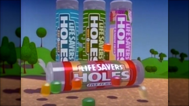 Screenshot from Life Savers Holes commercial with four tubes of candy and colorful individual candies