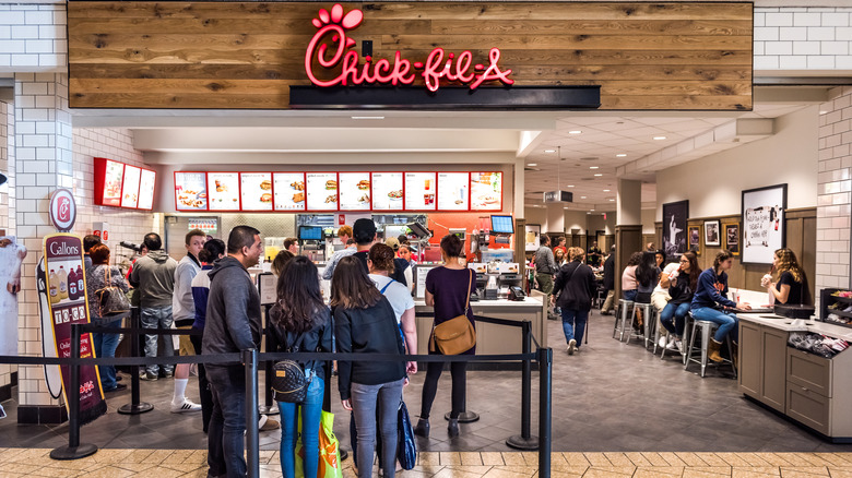 People waiting in a long line inside Chick-fil-A
