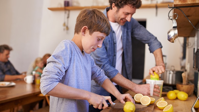 Father and son making lemonade