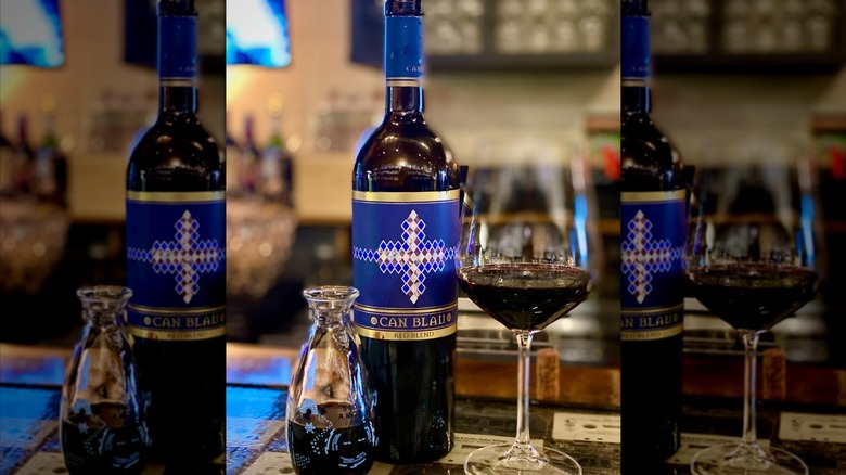 Bottle of Cellars Can Blau red blend next to wine glass
