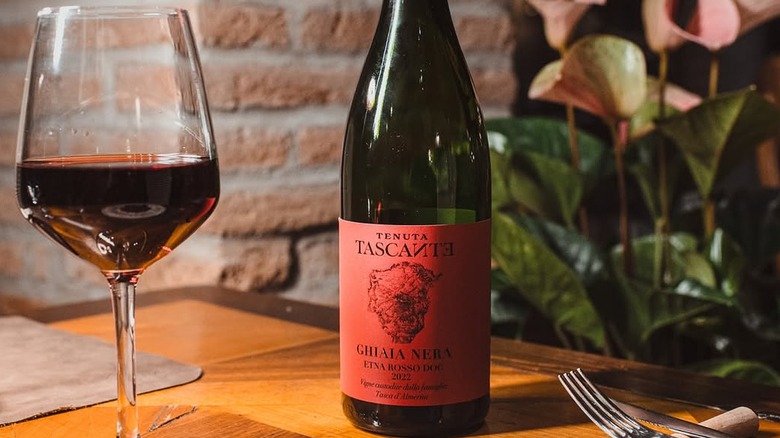 Bottle and glass of Tenuta Tascante Ghiaia Nera Etna Rosso DOC on restaurant table