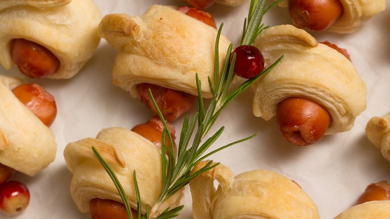 Pigs in blankets with rosemary and red currant