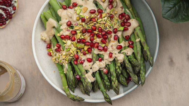 asparagus with tahini sauce and pomegranate