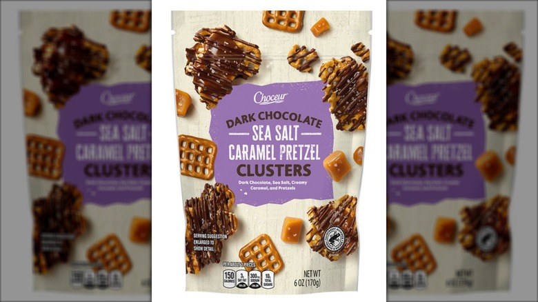Bag of dark chocolate sea salt caramel pretzel clusters against white background.