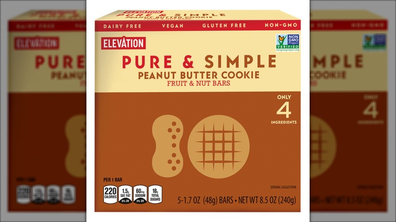 Box of peanut butter cookie fruit and nut bars against white background.