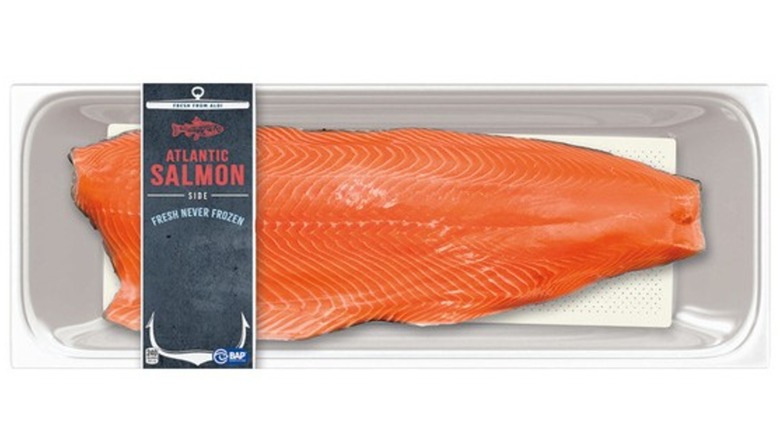 Package of Atlantic salmon filet against white background.