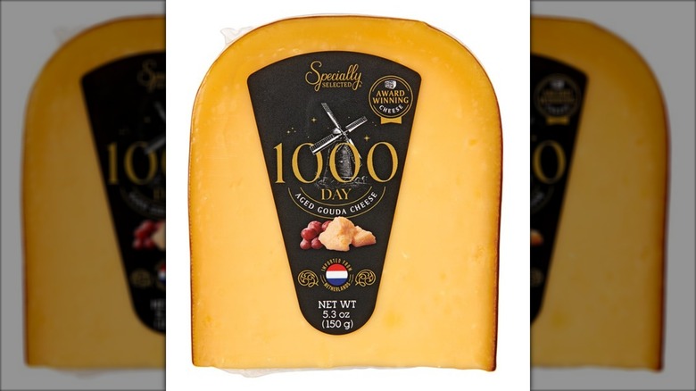 Pack of aged gouda cheese against white background.