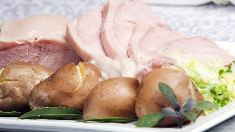 Irish bacon, cabbage and potatoes on white plate