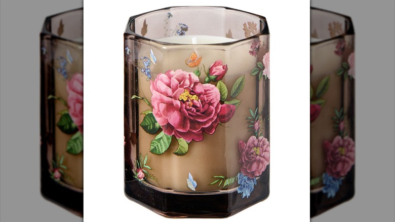 Candle in brown glass with floral design