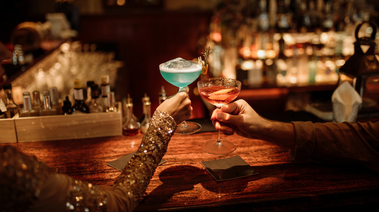 Bar couple toasting drinks