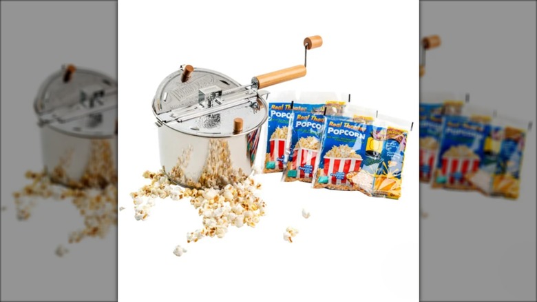 stainless steel popcorn popper with bags of kernels