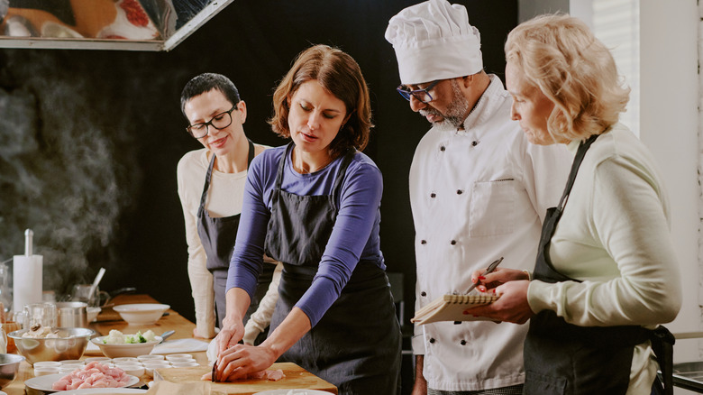A group of women and a chef teaching a cooking class
