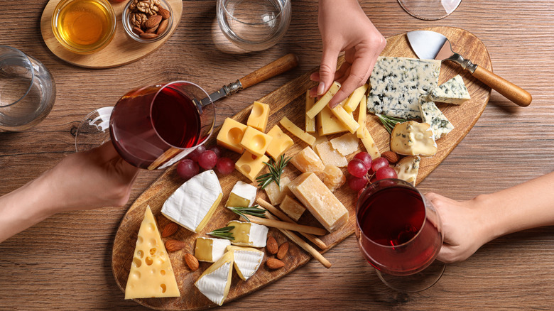 Friends enjoying wine and a cheese plate