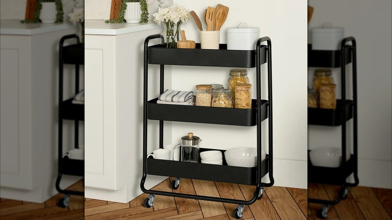 The Neatfreak 3-tier bar cart filled with dishes, towels, utensils, flowers, and more