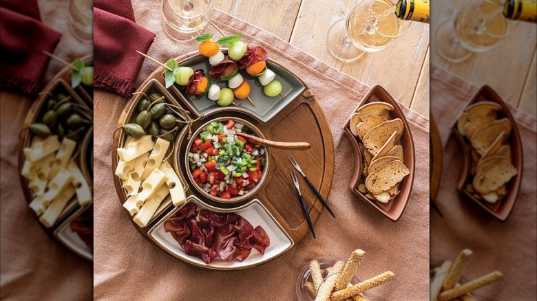 The over&back lazy Susan filled with meat, cheese, chips, and various fruits and vegetables