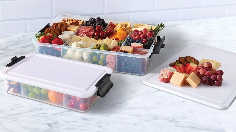 Two Sabatier Snackleboxes filled with fruit, meat, and cheese with the cutting board lid off
