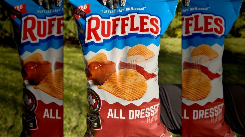hand holding bag of Ruffles All Dressed chips