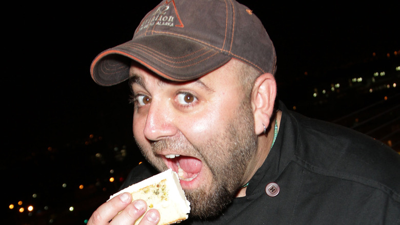 Duff Goldman about to take a big bite of food