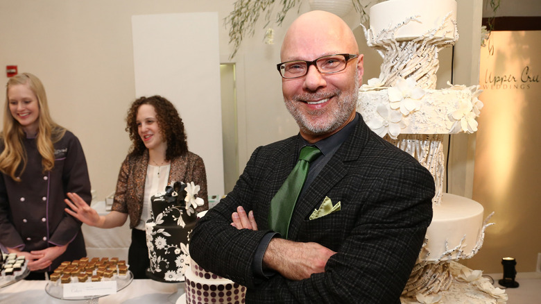 Ron Ben-Israel smiling in front of cakes