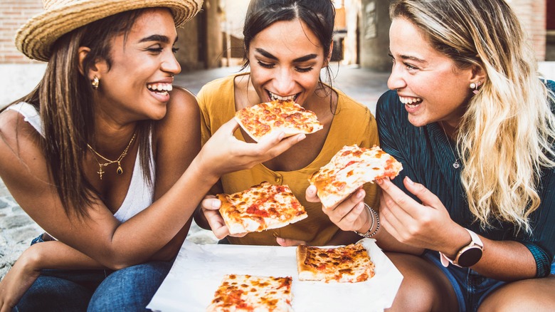 friends eating food outdoors